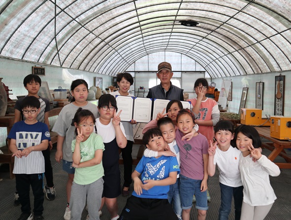 청보리지역아동센터와 대봉수묵원 송석응 대표가 업무협약을 맺고 센터 아이들과 함께 기념촬영을 하고 있다.