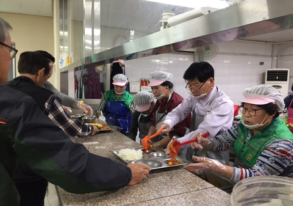 음성군새마을부녀회원들과 김기명 음성군새마을회장이 노인복지관 배식봉사활동에 참여하고 있다.