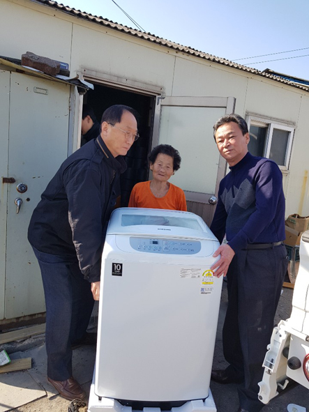 김장섭 음성읍장과 이양희 지역안전사회보장협 공동회장이 관내 주민에게 세탁기를 전달하고 있다.