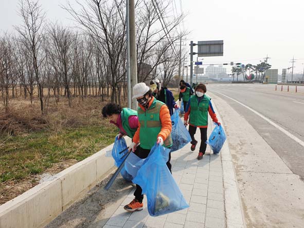 대소면민들이 도로 변에서 쓰레기를 수거하고 있다.