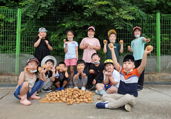감자를 캐고 기념촬영을 하고 있는 부윤초 어린이들 모습.