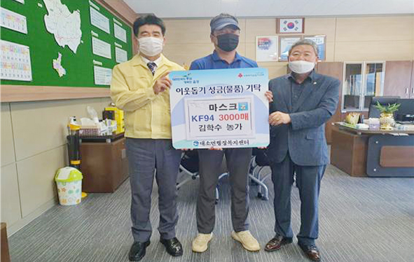 대소 김학수 씨(사진 가운데)가 대소면에 마스크를 전달하고 현연호 면장(사진 왼쪽), 김영호 군의원(사진 오른쪽)과 기념촬영을 하고 있다.