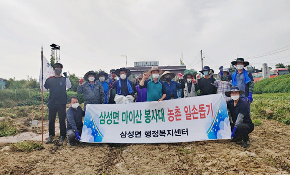 삼성행정복지센터 직원들이 농촌일손돕기 활동에 나서며 기념촬영을 하고 있다.